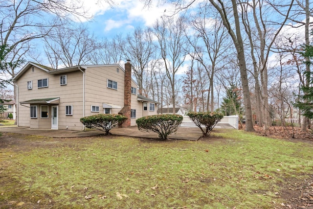 view of side of property with a yard and a patio