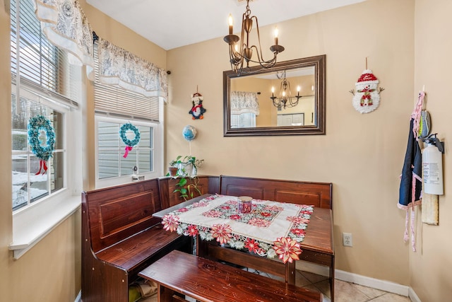 dining area featuring light tile patterned floors and a chandelier