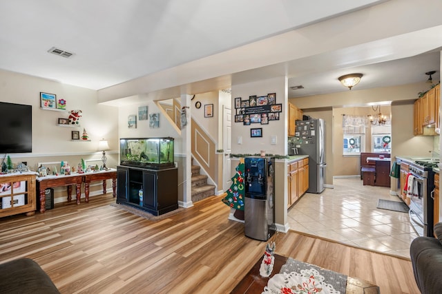 living room featuring a notable chandelier and light hardwood / wood-style floors