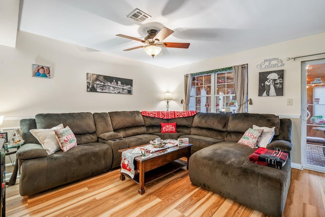 living room with hardwood / wood-style floors and ceiling fan