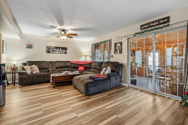 living room with light wood-type flooring and ceiling fan