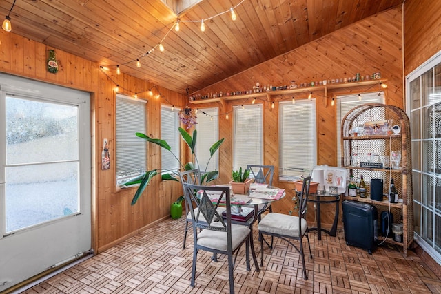 dining area featuring wood ceiling, wood walls, lofted ceiling, and parquet flooring