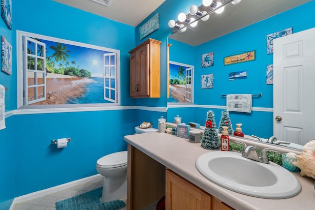 bathroom with tile patterned flooring, vanity, and toilet