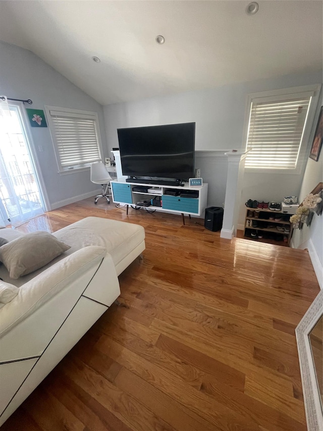 living room featuring lofted ceiling and hardwood / wood-style floors