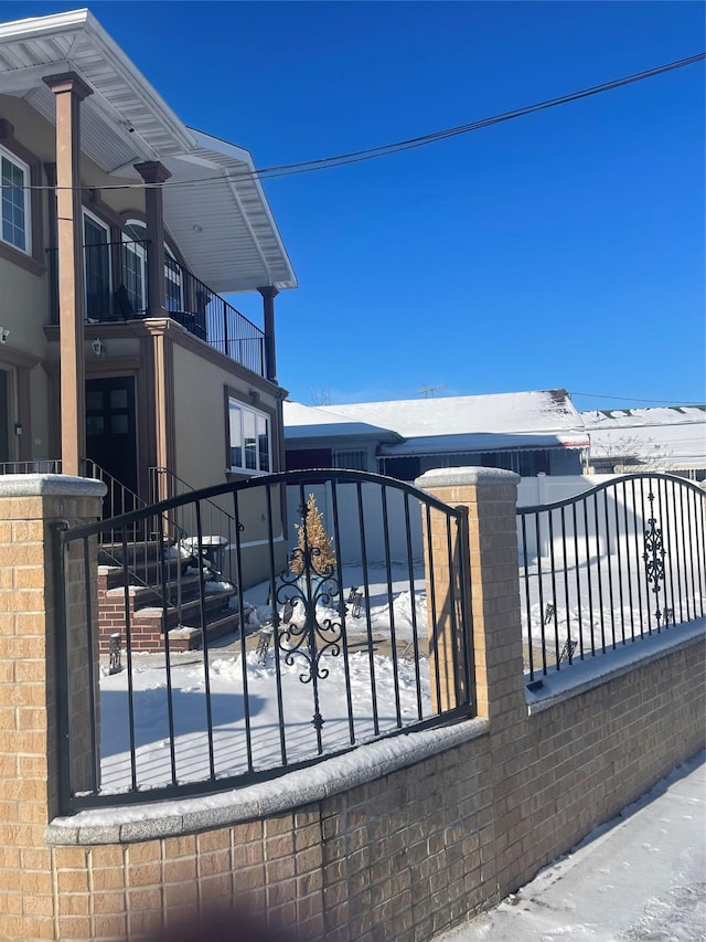 view of snow covered gate