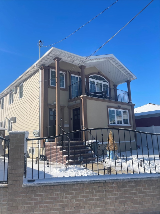 view of side of home featuring a balcony