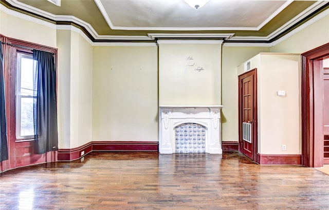 unfurnished living room with hardwood / wood-style flooring and crown molding