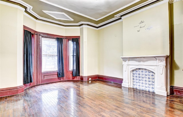 unfurnished living room with hardwood / wood-style floors and ornamental molding