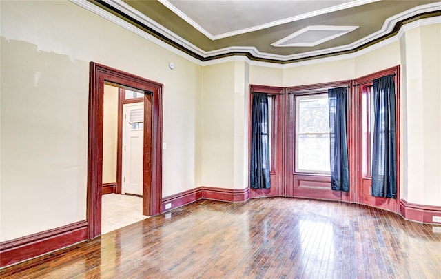 empty room with light hardwood / wood-style floors and crown molding