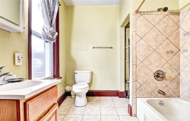 full bathroom with tile patterned floors, vanity, tiled shower / bath combo, and toilet