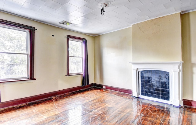 unfurnished living room with hardwood / wood-style floors and ornamental molding