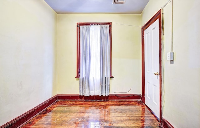 empty room featuring wood-type flooring and a wealth of natural light