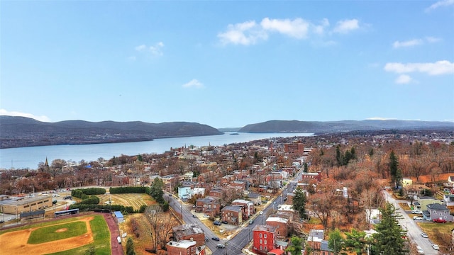 birds eye view of property with a water and mountain view