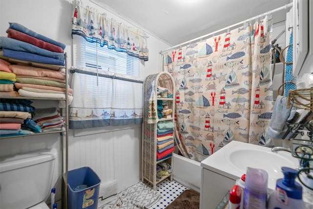 bathroom with shower / bathtub combination with curtain, ornamental molding, and toilet