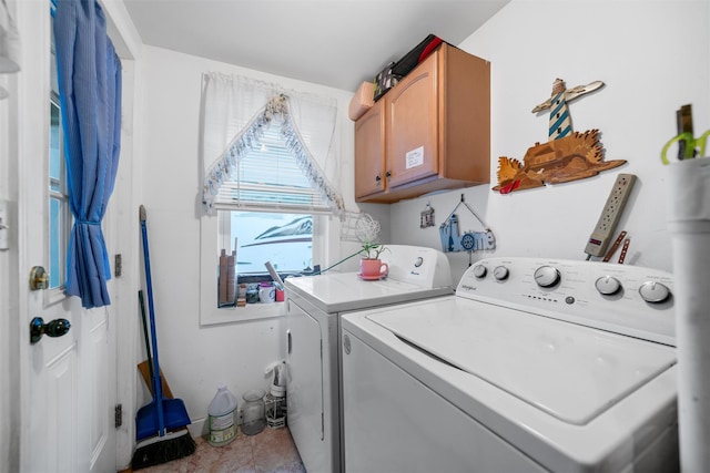 washroom featuring washing machine and dryer and cabinets