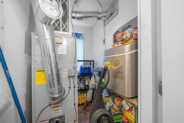 utility room featuring heating unit