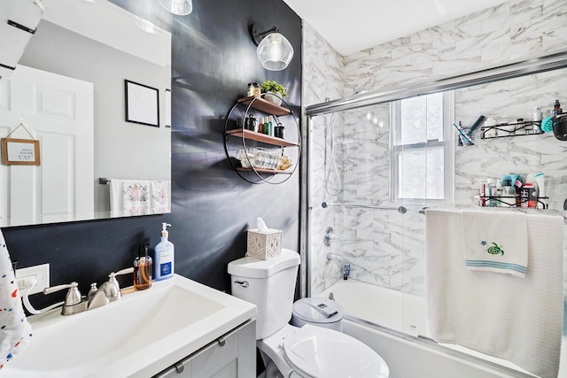 full bathroom with shower / bath combination with glass door, vanity, and toilet