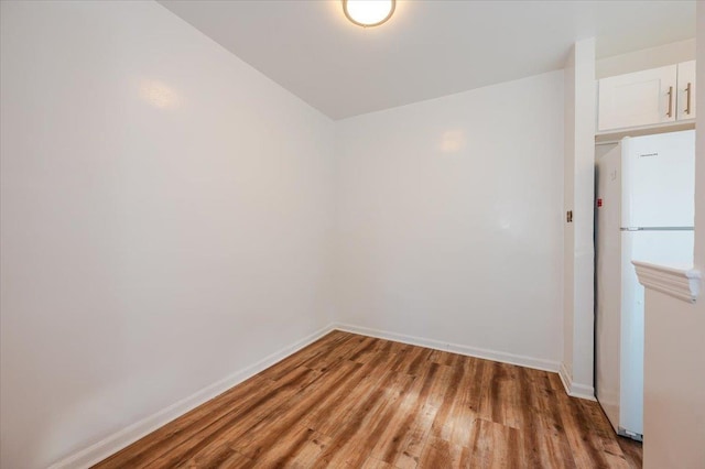 spare room with wood-type flooring