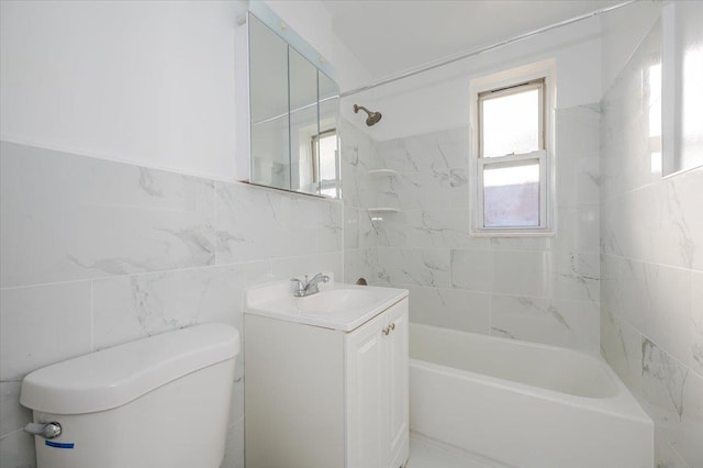 full bathroom featuring vanity, toilet, tile walls, and tiled shower / bath combo