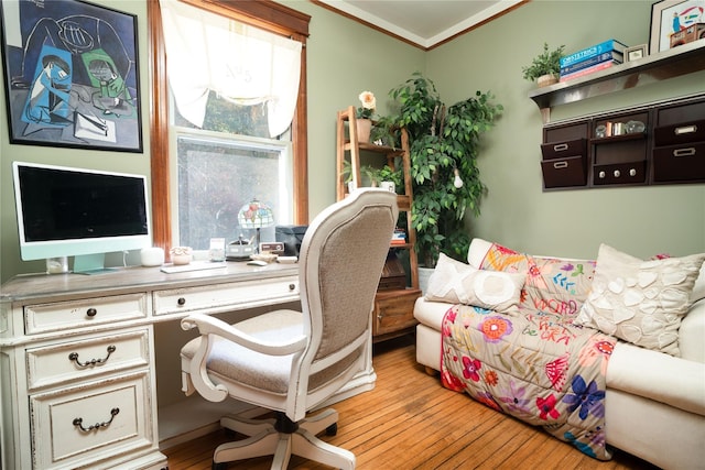 office area with light hardwood / wood-style floors and crown molding