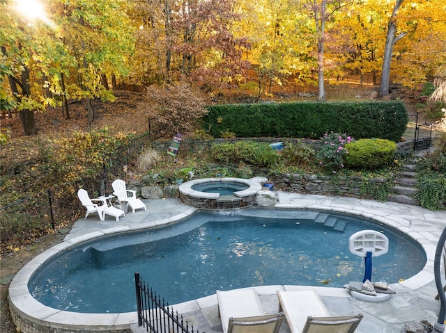 view of pool with an in ground hot tub