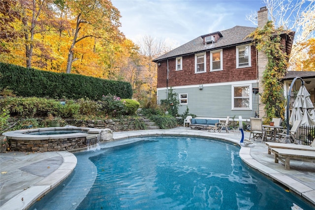 view of pool featuring an outdoor living space, a pool with connected hot tub, and a patio