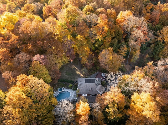 drone / aerial view featuring a wooded view