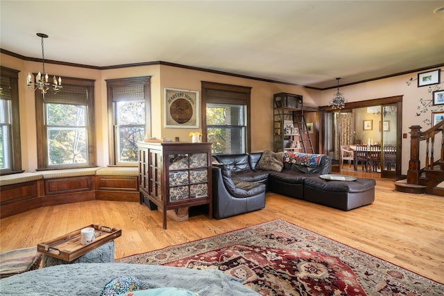 living room with wood finished floors, a notable chandelier, and ornamental molding