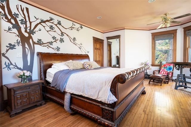 bedroom featuring hardwood / wood-style floors, recessed lighting, and crown molding