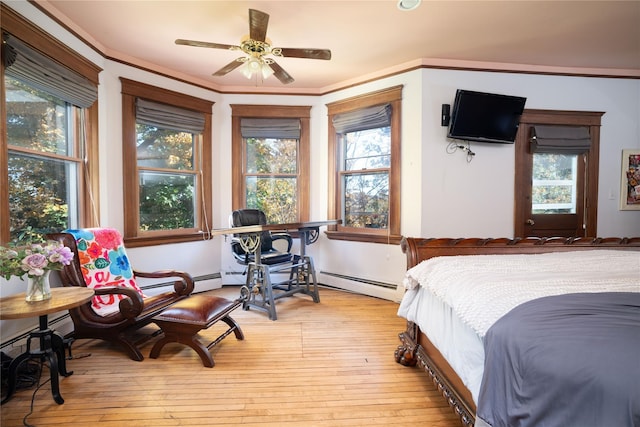 bedroom featuring wood-type flooring, ornamental molding, a baseboard radiator, and multiple windows