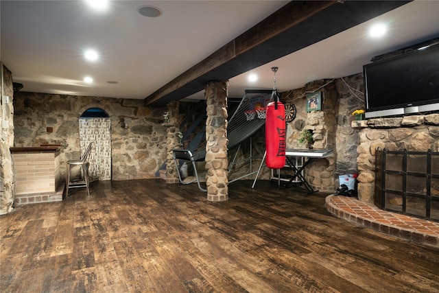 finished basement featuring wood finished floors and a fireplace
