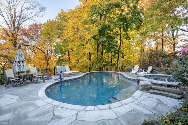 view of pool with an outdoor fire pit, a patio area, a fenced backyard, and a fenced in pool