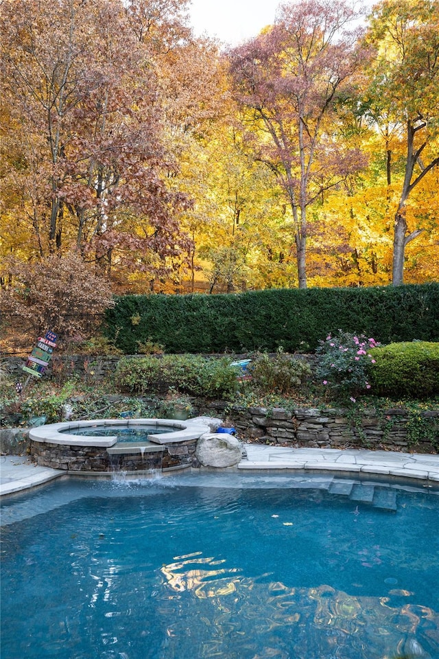 view of pool featuring a pool with connected hot tub