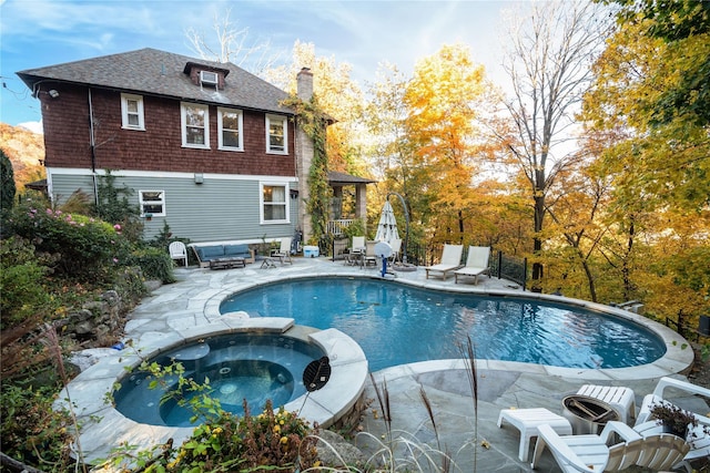 view of swimming pool featuring an outdoor living space, a patio, and a pool with connected hot tub