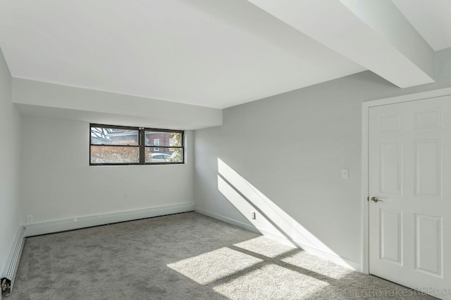 additional living space with light carpet and a baseboard radiator