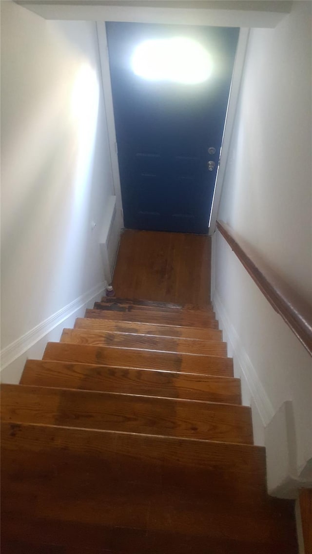 stairs featuring wood-type flooring