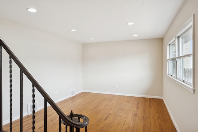 unfurnished room with hardwood / wood-style floors