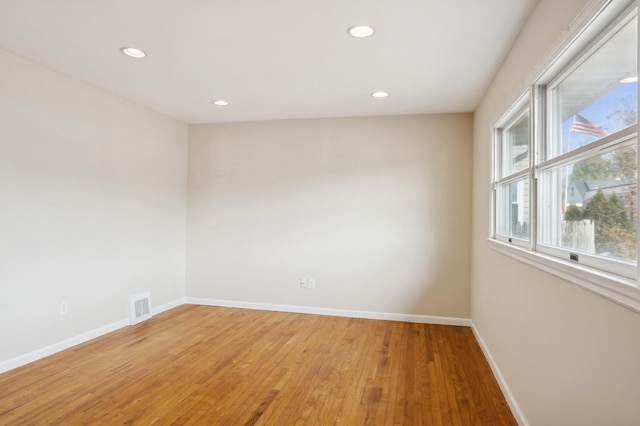 unfurnished room with hardwood / wood-style floors