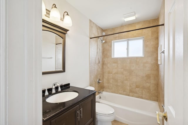 full bathroom with vanity, tiled shower / bath combo, and toilet