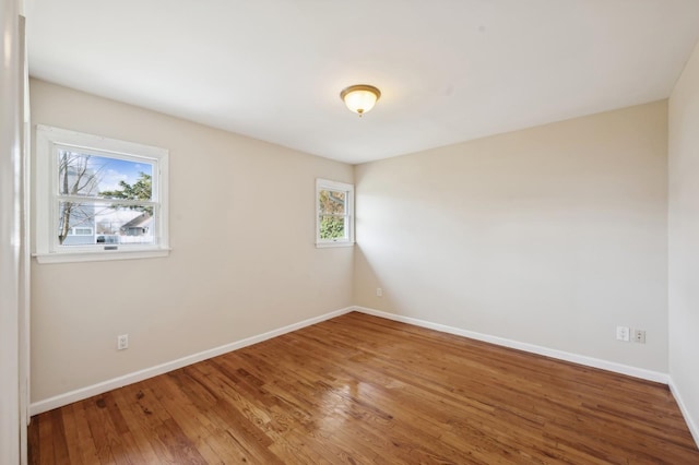 spare room featuring wood-type flooring and a wealth of natural light