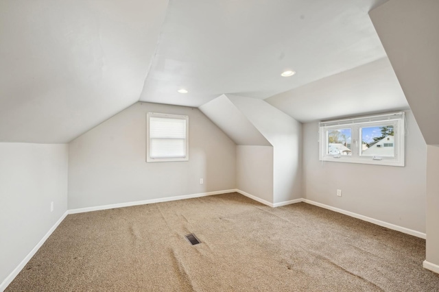 additional living space with carpet and vaulted ceiling