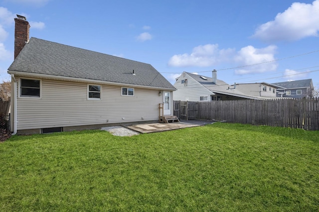 back of house with a patio area and a lawn