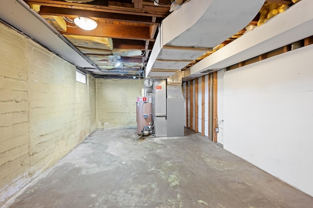 basement featuring heating unit and water heater