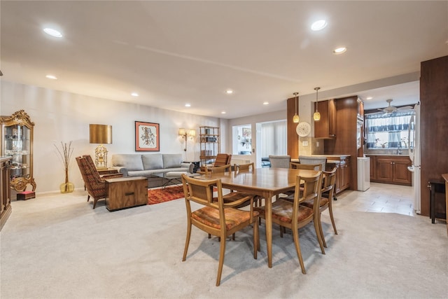 carpeted dining space with plenty of natural light