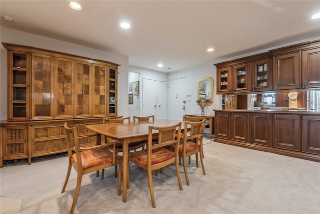 dining room featuring light carpet