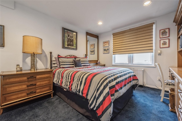 bedroom with dark carpet and radiator