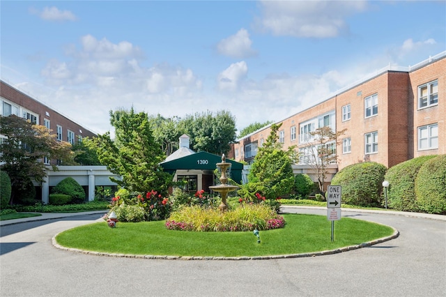 view of property's community with a lawn