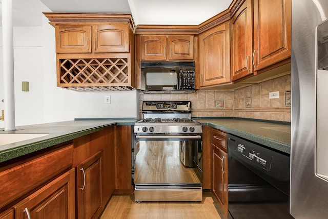 70-25 Yellowstone Blvd Unit 6O, Forest Hills, NY 11375 - kitchen with black appliances, dark countertops, light wood finished floors, backsplash, and brown cabinets
