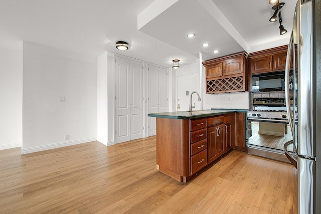 70-25 Yellowstone Blvd Unit 6O, Forest Hills, NY 11375 - kitchen featuring range with gas stovetop, black microwave, a peninsula, freestanding refrigerator, and dark countertops