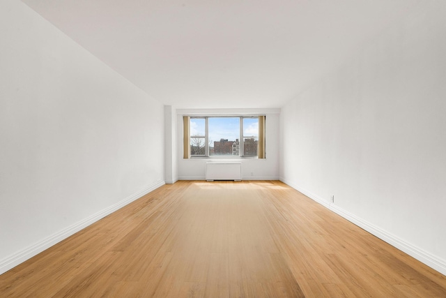 70-25 Yellowstone Blvd Unit 6O, Forest Hills, NY 11375 - unfurnished room with radiator and light wood-type flooring